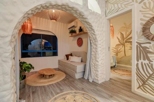a living room with a couch and a table at Apartamento Studio Grécia - Ondina in Salvador
