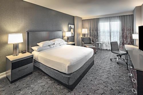 a hotel room with a bed and a desk at DoubleTree by Hilton Modesto in Modesto