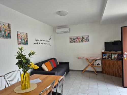 a living room with a couch and a table at Le Mimose Holiday House di Como - Grandate in Grandate