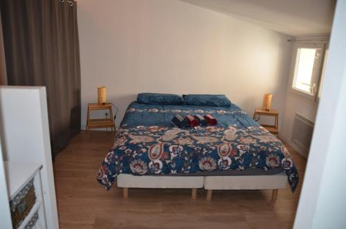une chambre avec un lit avec une couette bleue dans l'établissement Maison en coeur de ville, à LʼIsle-sur-la-Sorgue