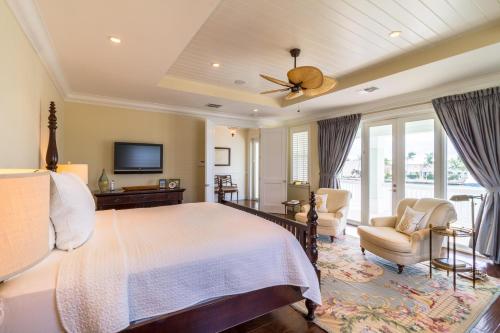 a bedroom with a large bed with a ceiling fan at The Vaca House in Marathon