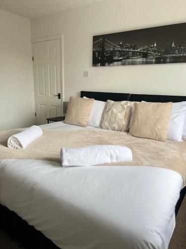 a large bed with two pillows on top of it at Olive Lodge in Southampton