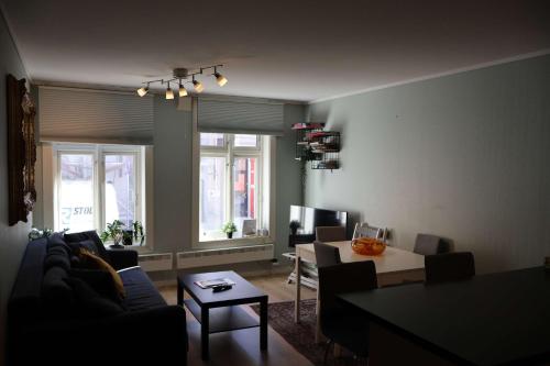 a living room with a couch and a table at Dinbnb Apartments I Charming 3-Bedroom in the Heart of the City in Bergen