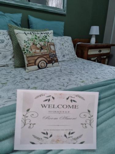 a sign on a bed with a welcome sign on it at Grace B&B in Potchefstroom