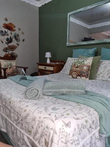 a bedroom with a bed and a mirror on the wall at Grace B&B in Potchefstroom