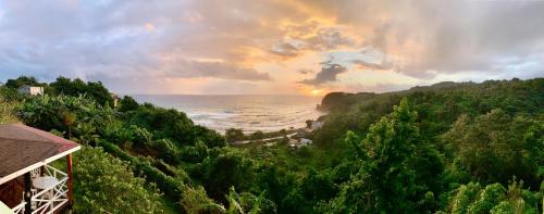 a view of the ocean from a hill with a sunset at I VIEW - in Long Bay in Long Bay Village