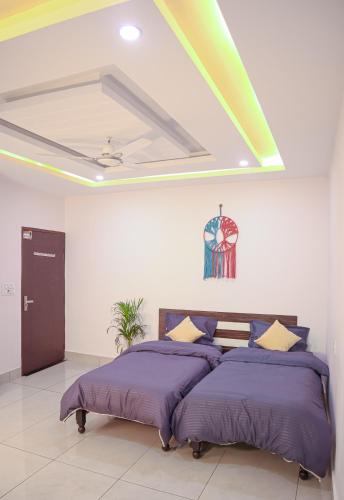 a bedroom with a large bed with purple pillows at Blissfull stay midsts nature in Rishīkesh