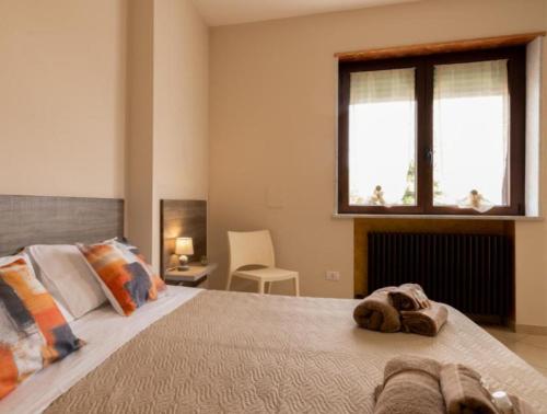 a bedroom with a large bed with two towels on it at Dimora Costa Del Sole in Gallipoli