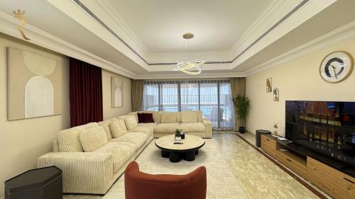 a living room with a couch and a table at Al Raha 4BR Oasis Elegant Luxury Retreat in Abu Dhabi
