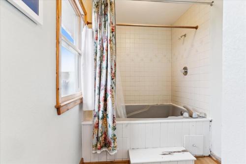 a bath tub in a bathroom with a window at D130 - Shannon in Duck