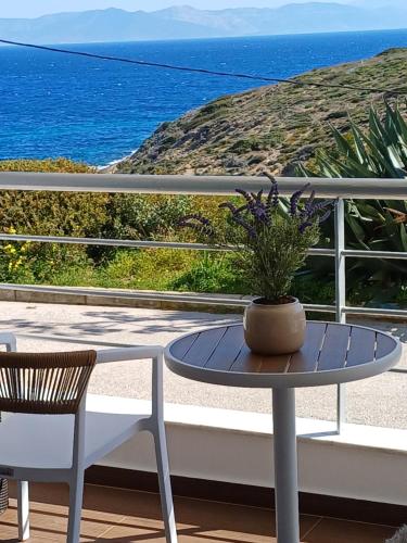 a table and chairs on a balcony with the ocean at RAFINAS PARADISE VIEW!! Walking access to the Port!! Amazing Seaview!!! in Rafina
