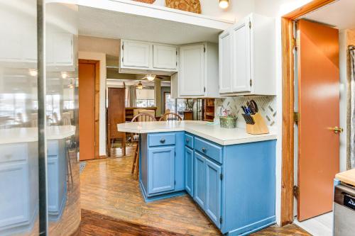 a kitchen with blue cabinets and white counter tops at Ice Fish, Hunt and Explore Farwell Home on Lake in Farwell
