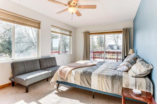 a bedroom with a bed and a couch and windows at Ice Fish, Hunt and Explore Farwell Home on Lake in Farwell