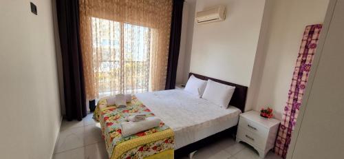 a small bedroom with a bed and a window at Best life 6 in Alanya