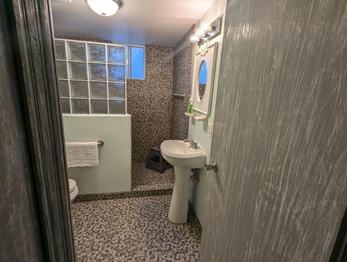 a bathroom with a sink and a toilet and a mirror at Sea Breeze Retreat 301 in Puerto Peñasco