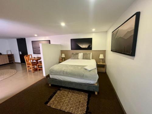 a bedroom with a bed and a dining room at Ope Suites calle 100 in Bogotá