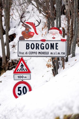 a sign for a bergdorff mountain in the snow at Chalet Casa dei Nonni in Ceppo Morelli