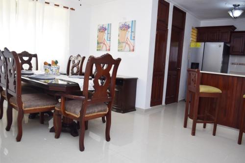 a kitchen with a dining room table and chairs at Relax in this apartment in Santiago de los Caballeros