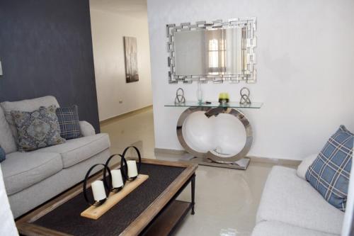 a living room with a couch and a table at Relax in this apartment in Santiago de los Caballeros
