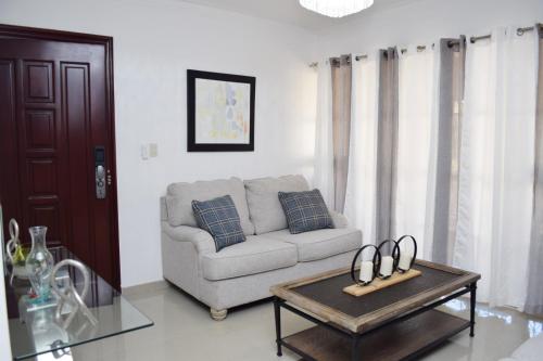 a living room with a couch and a coffee table at Relax in this apartment in Santiago de los Caballeros
