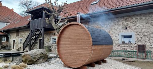 a large wooden surfboard in front of a building at Statek Kloubek in Chabičovice