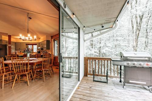 a screened in porch with a table and chairs on a deck at Serenity Ridge in Dillard