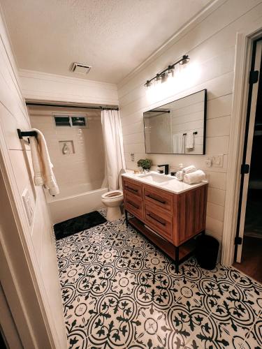 a bathroom with a sink and a toilet and a mirror at Serenity Ridge in Dillard