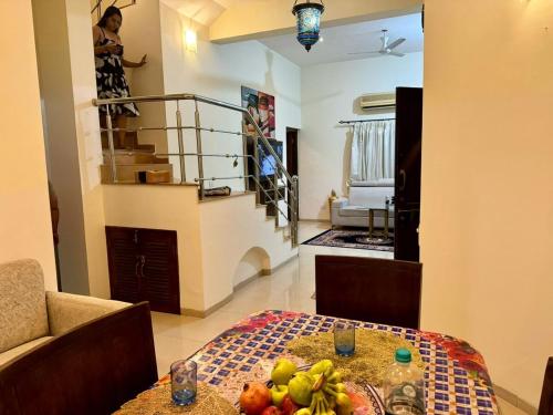 a living room with a table with fruit on it at Golden Sun ray beach villa in Saligao