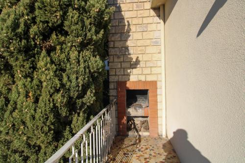 une vue de tête sur un mur de briques à côté d'un arbre dans l'établissement Clos Garrigue, à Poulx