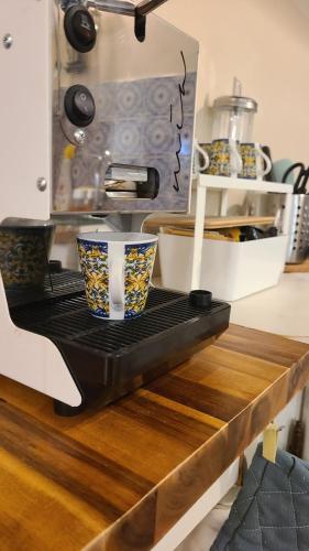 a kitchen counter with a coffee maker on top of it at Stirpe nel Bosco - Fiocco in Montevettolini