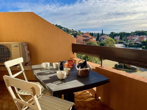 une table et des chaises sur un balcon avec vue dans l'établissement Appartement moderne 2 pièces avec balcon et parking à La Londe-les-Maures - FR-1-826-2, à La Londe-les-Maures