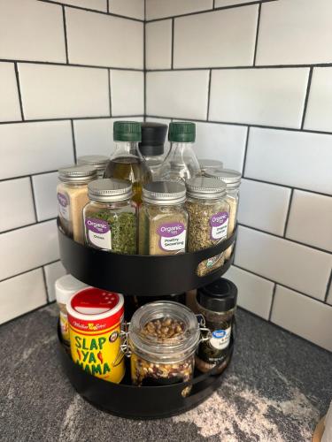 a shelf in a kitchen filled with jars of food at Firefly2 - luxury lakeside treehouse with hot tub in Eureka Springs