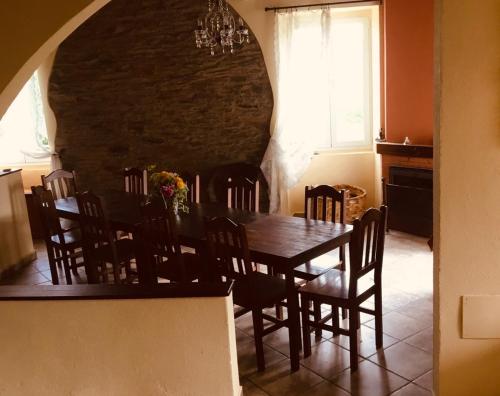 a dining room with a wooden table and chairs at Villa Auristela in Navia