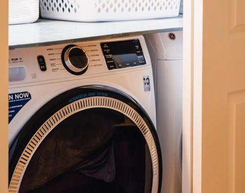 a washing machine under a counter in a room at Peaceful Catskills Creek House in Saugerties