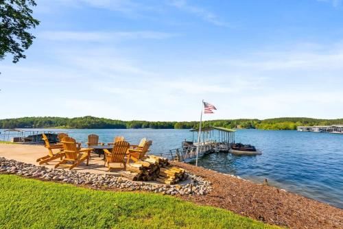 a dock with chairs and a table and a boat at DockTales - Panoramic Views & Private Dock in Six Mile