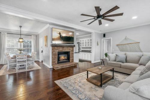 a living room with a couch and a fireplace at DockTales - Panoramic Views & Private Dock in Six Mile