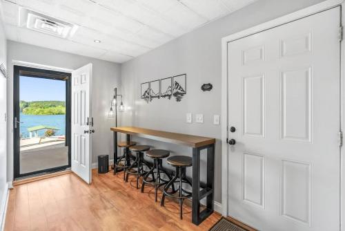 a kitchen with a bar with stools at DockTales - Panoramic Views & Private Dock in Six Mile