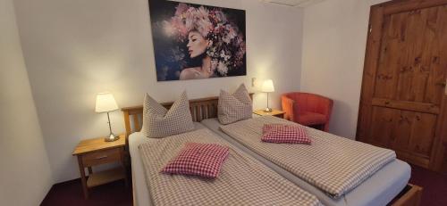 a bedroom with a bed with two pillows on it at Hotel Meridian in Görlitz
