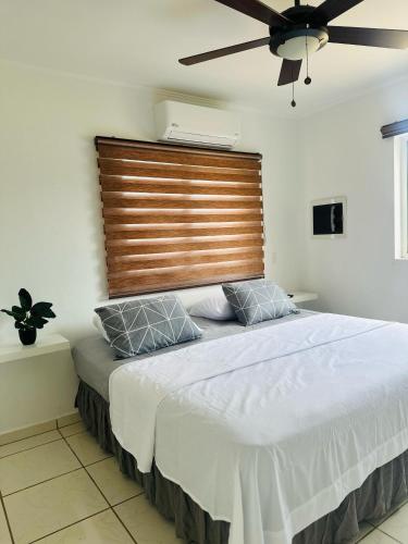 a bedroom with a large bed with a wooden headboard at Fontains Vacation House in Palm-Eagle Beach