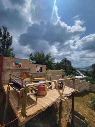 a wooden deck with a bench on top of it at EMMY'S HIDE AWAY in Iringa