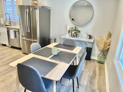 a kitchen with a table with chairs and a refrigerator at Superb Luxurious 3Br in the Heart of Providence in Providence