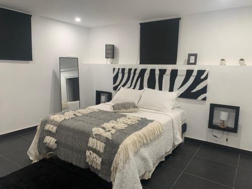 a bedroom with a large bed in a room at Paradiso Apartments - 1 BDR in Oranjestad