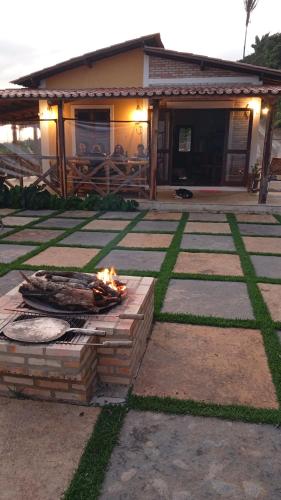 a fire pit in a yard in front of a house at Chalé do talhado in Ibiapina