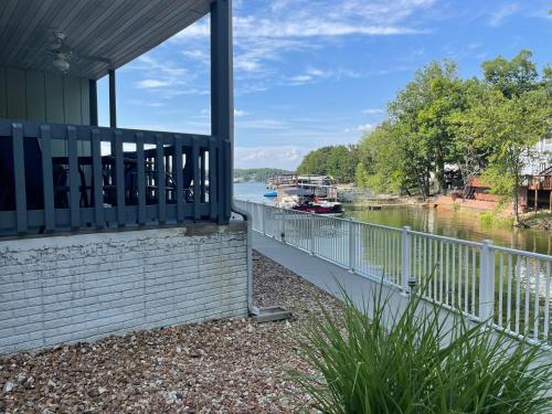 a balcony of a house next to a river at STAIRS OPTIONAL! Lakefront! Pool! On Water! Convenient Fishing! in Osage Beach