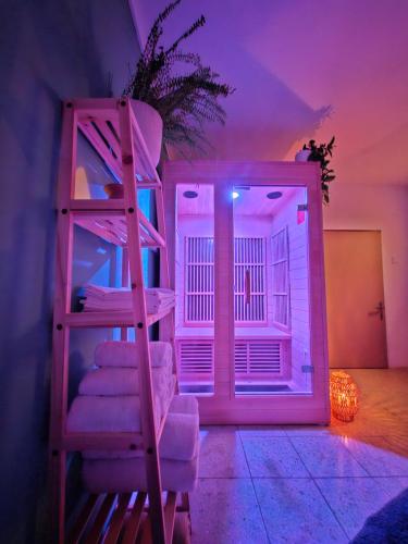 a room with a bunk bed with a ladder at Chatička Lukov in Lukov