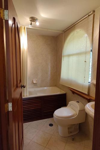 a bathroom with a toilet and a bath tub at Posadas del Castillo del Titicaca in Vencalla