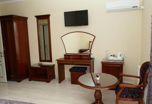 a living room with a mirror and a table at Prima Villa Guest House in Vinnytsya