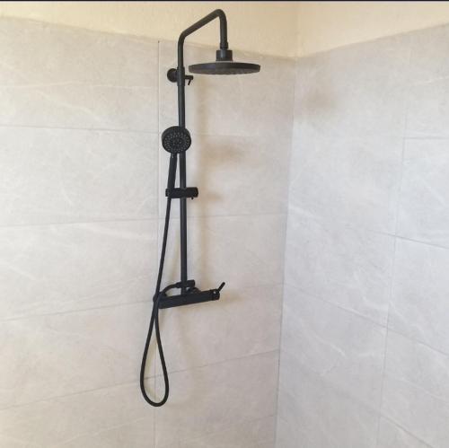 a shower in a bathroom with a shower head at Halle Hotel - Lalibela in Lalībela