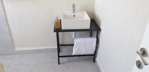 a bathroom with a sink on a black table at Halle Hotel - Lalibela in Lalībela