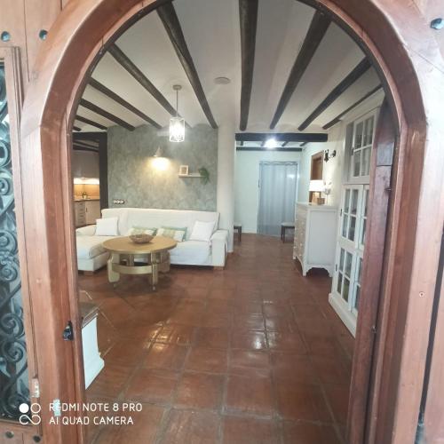 a living room with a white couch and a table at Villa Calamaco in Los Gallardos